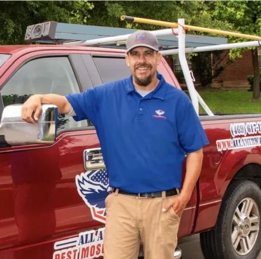 Zane, owner of All American PML, standing in front of his branded service truck